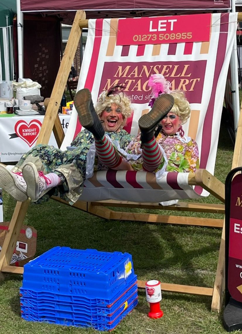 The Ugly Sisters sitting in a giant deck chair at Patcham Duck Fayre